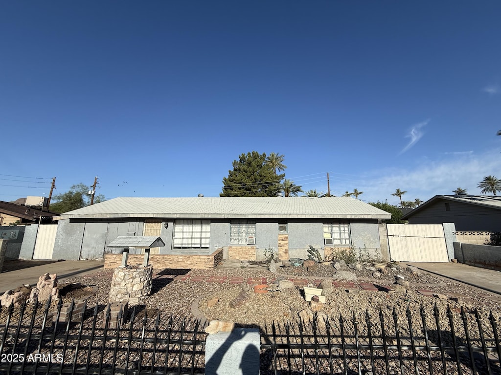 view of front of home featuring fence
