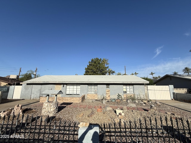 view of front of home featuring fence