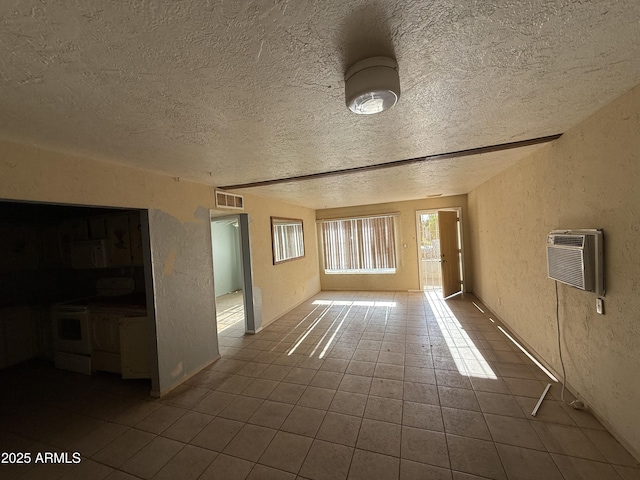 4310 N 42nd Pl, Phoenix, AZ 85018 - unfurnished living room with a textured wall, dark tile patterned floors, a textured ceiling, and a wall mounted air conditioner