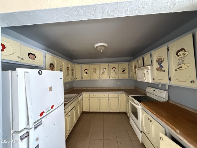 4310 N 42nd Pl, Phoenix, AZ 85018 - kitchen with white appliances, tile patterned flooring, cream cabinetry, and a sink