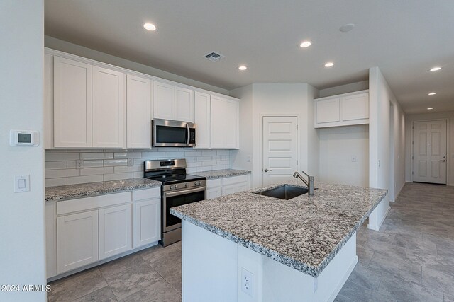 bathroom featuring tile patterned flooring, vanity, and a shower with shower door