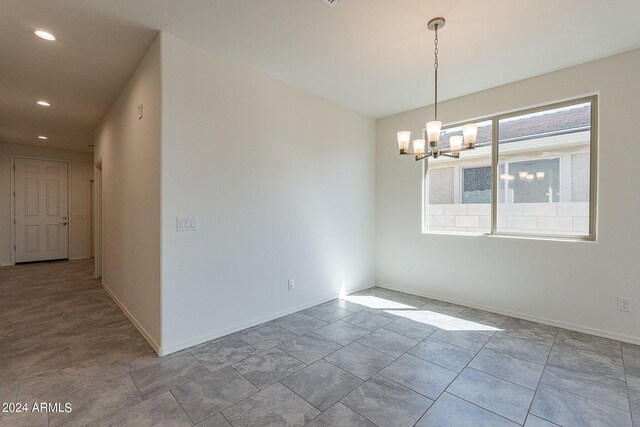 kitchen with stove, white cabinets, hanging light fixtures, decorative backsplash, and light stone countertops