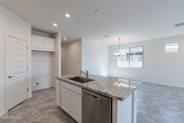 kitchen featuring white cabinetry, sink, stainless steel dishwasher, and a center island with sink