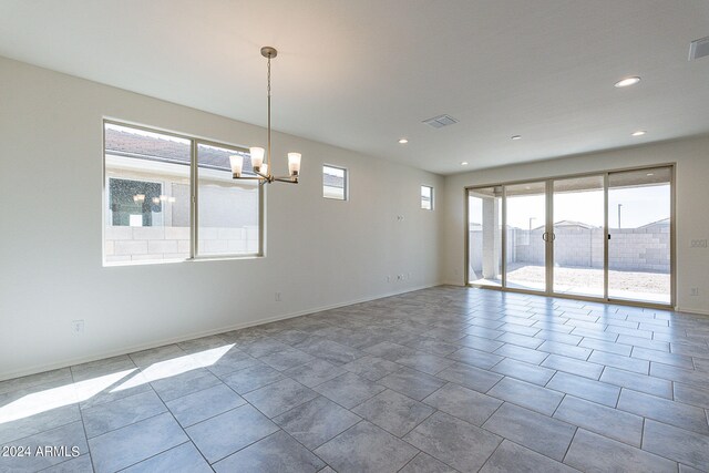 kitchen with sink, white cabinets, stainless steel appliances, and a center island with sink