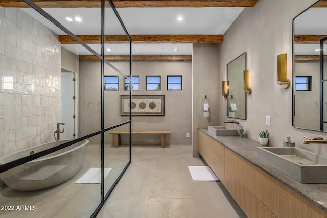 bathroom with beamed ceiling, a freestanding tub, and a sink