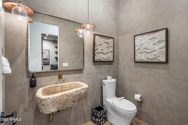 half bathroom featuring a sink and toilet