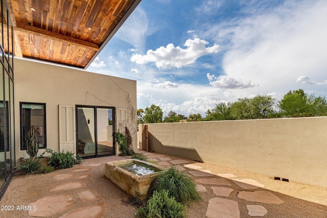 view of patio featuring fence