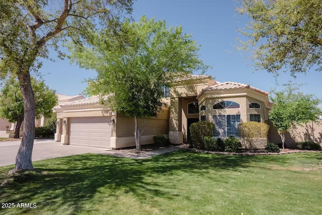 view of front of home featuring a front yard and a garage