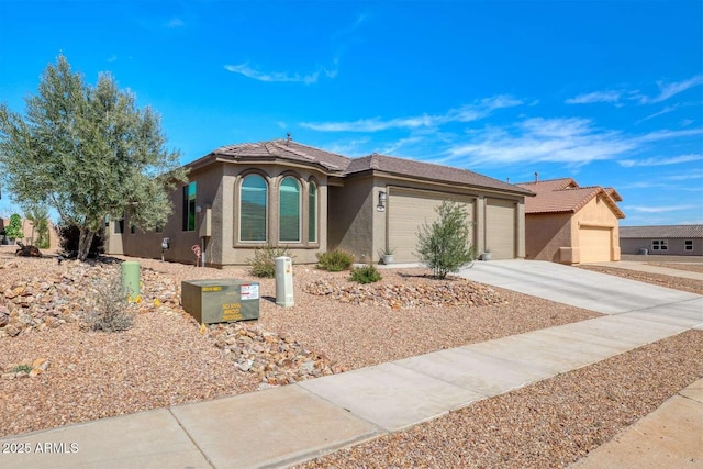 ranch-style house with an attached garage, concrete driveway, and stucco siding