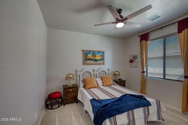 carpeted bedroom featuring visible vents, ceiling fan, and baseboards