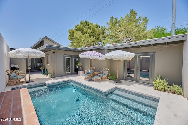 rear view of house featuring a patio area and french doors