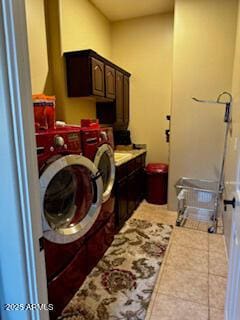 laundry room with washer and clothes dryer, tile patterned flooring, and cabinet space