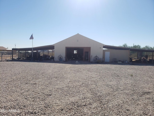 exterior space with stucco siding and a detached garage