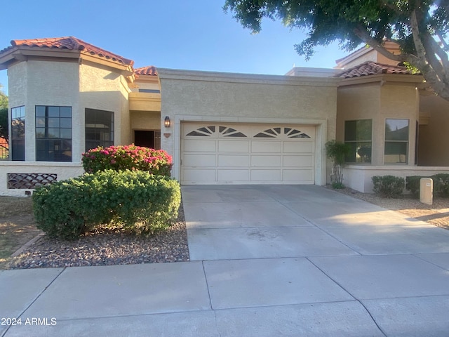 mediterranean / spanish-style house featuring a garage