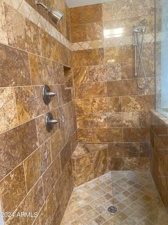 bathroom with tiled shower