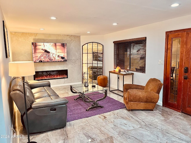 living room with a tiled fireplace