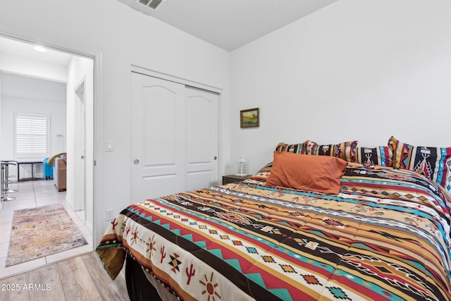 bedroom featuring a closet and light hardwood / wood-style flooring