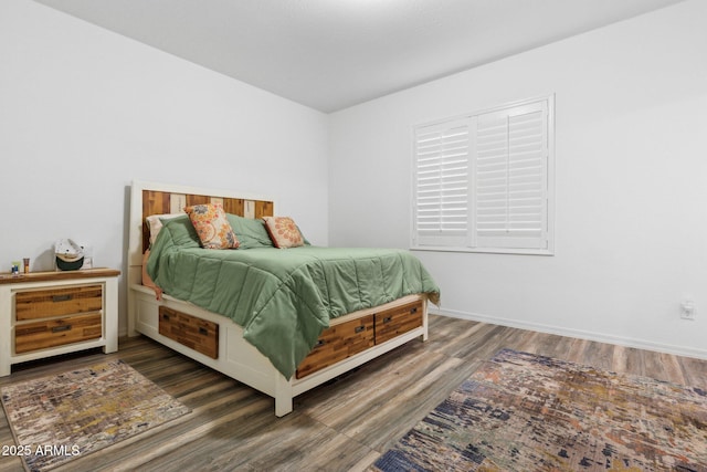 bedroom with dark hardwood / wood-style floors