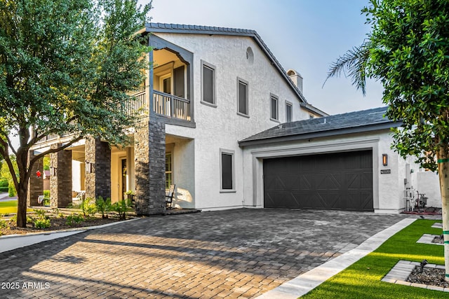 20866 W Werner Pl, Buckeye, AZ 85396 - view of front of house featuring a balcony, stucco siding, a garage, and driveway