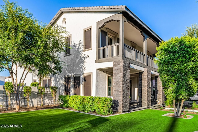 20866 W Werner Pl, Buckeye, AZ 85396 - view of front facade featuring a balcony, stucco siding, and a front yard