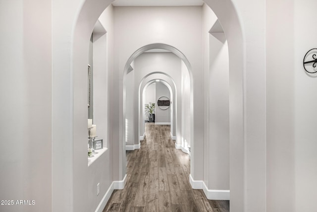 20866 W Werner Pl, Buckeye, AZ 85396 - hall with wood finished floors, arched walkways, and baseboards