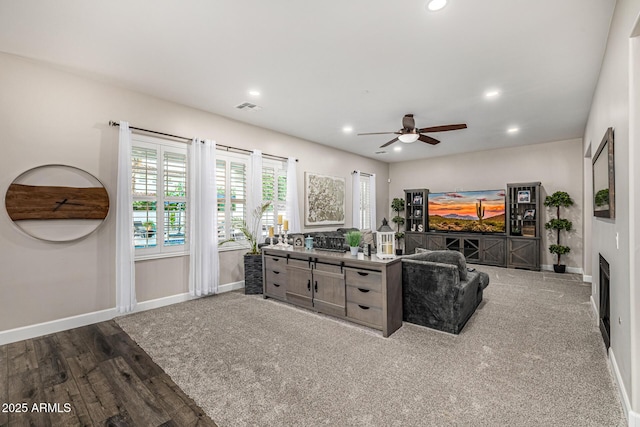20866 W Werner Pl, Buckeye, AZ 85396 - living room with recessed lighting, baseboards, ceiling fan, wood finished floors, and a fireplace