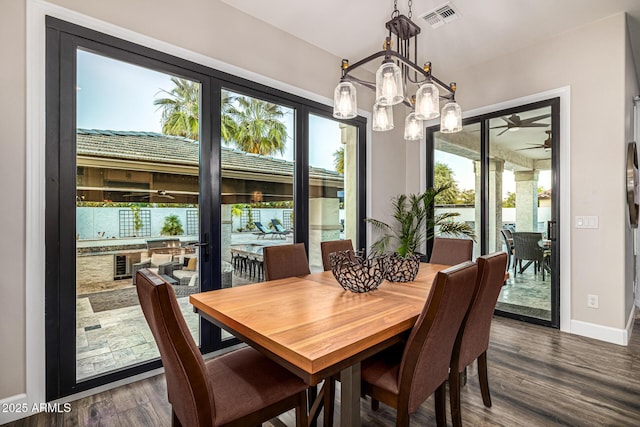 20866 W Werner Pl, Buckeye, AZ 85396 - dining space with healthy amount of natural light, dark wood-type flooring, and baseboards