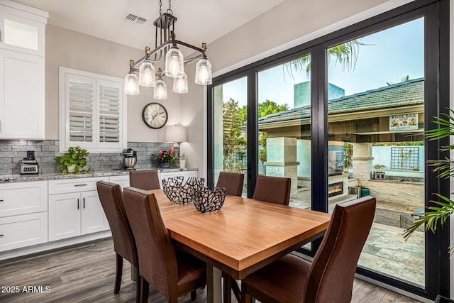 20866 W Werner Pl, Buckeye, AZ 85396 - dining space featuring wood finished floors and a chandelier
