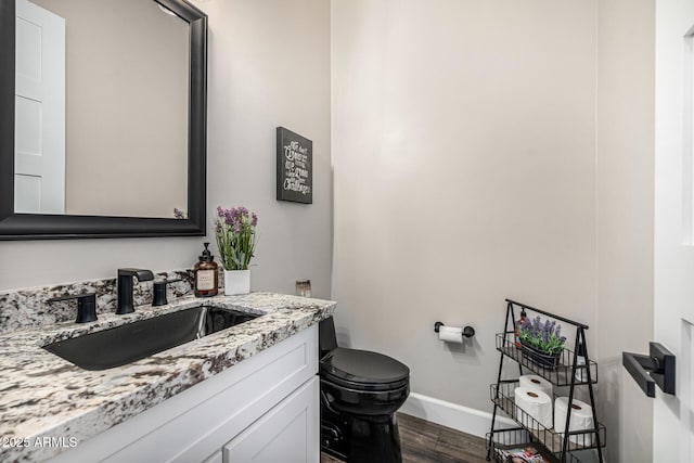 20866 W Werner Pl, Buckeye, AZ 85396 - bathroom featuring wood finished floors, toilet, baseboards, and vanity