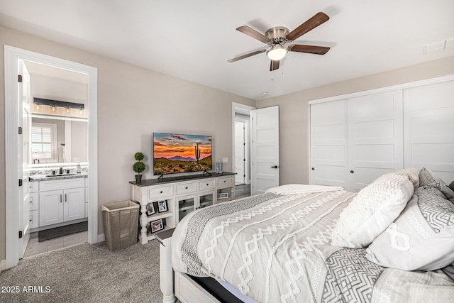 20866 W Werner Pl, Buckeye, AZ 85396 - bedroom featuring a closet, ensuite bathroom, a sink, light colored carpet, and ceiling fan