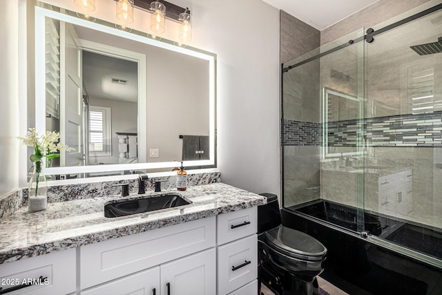 20866 W Werner Pl, Buckeye, AZ 85396 - full bathroom with vanity, bath / shower combo with glass door, and toilet