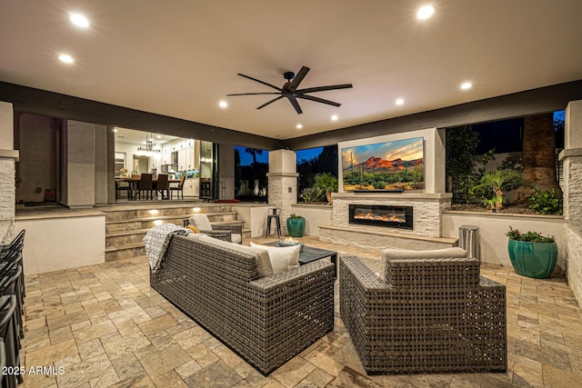 20866 W Werner Pl, Buckeye, AZ 85396 - view of patio / terrace with an outdoor living space with a fireplace and a ceiling fan