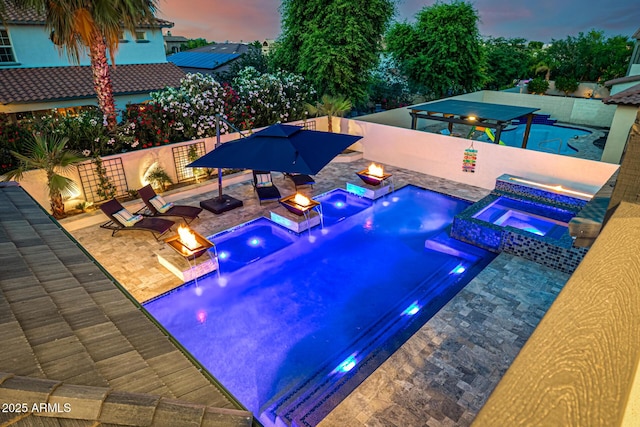 20866 W Werner Pl, Buckeye, AZ 85396 - view of pool with a fire pit, a patio, a pool with connected hot tub, and a fenced backyard