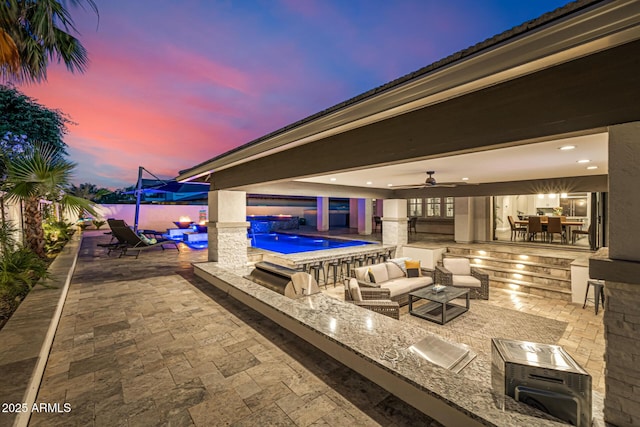 20866 W Werner Pl, Buckeye, AZ 85396 - fenced backyard with area for grilling, an outdoor bar, a patio, an outdoor living space, and a ceiling fan