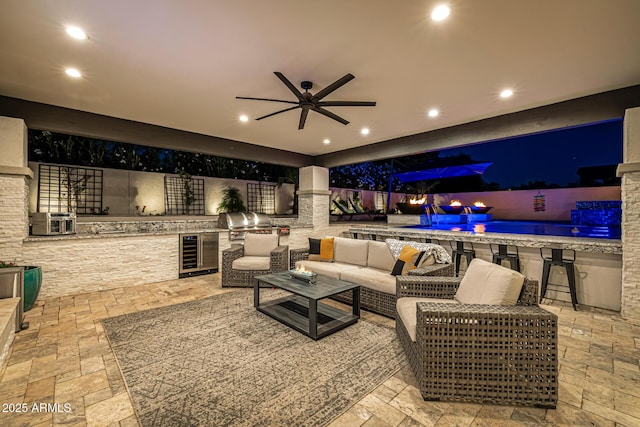 20866 W Werner Pl, Buckeye, AZ 85396 - living room with beverage cooler, stone tile flooring, a ceiling fan, and recessed lighting