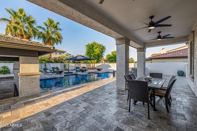 20866 W Werner Pl, Buckeye, AZ 85396 - fenced backyard featuring a patio area, a ceiling fan, and outdoor dining space
