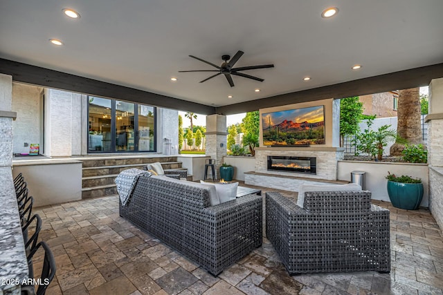 20866 W Werner Pl, Buckeye, AZ 85396 - view of patio / terrace with a ceiling fan and an outdoor living space with a fireplace