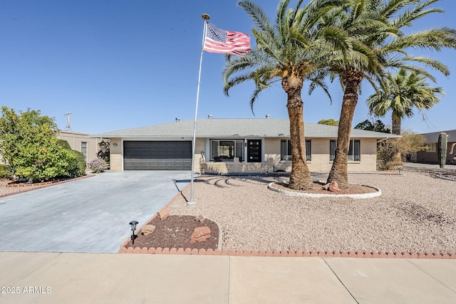 ranch-style home featuring a garage, brick siding, and concrete driveway