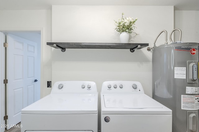 clothes washing area with washer and dryer, laundry area, and electric water heater