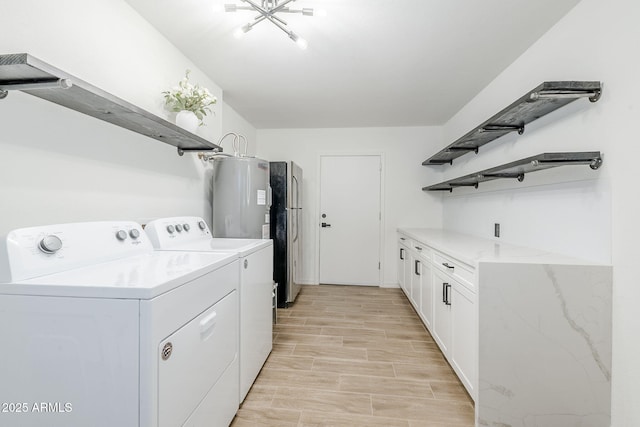 laundry room with washer and dryer, wood finish floors, cabinet space, and electric water heater