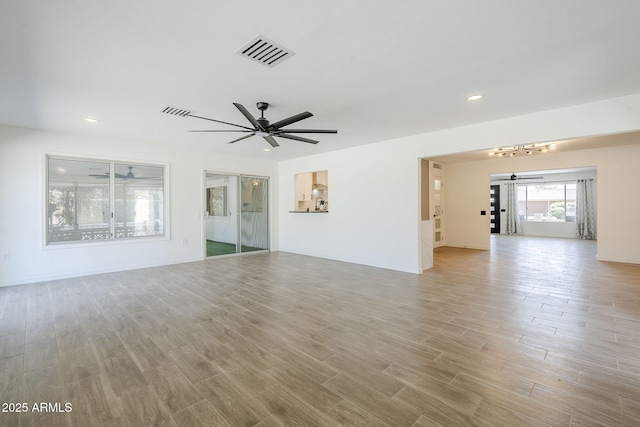 unfurnished living room with recessed lighting, visible vents, wood finished floors, and a ceiling fan