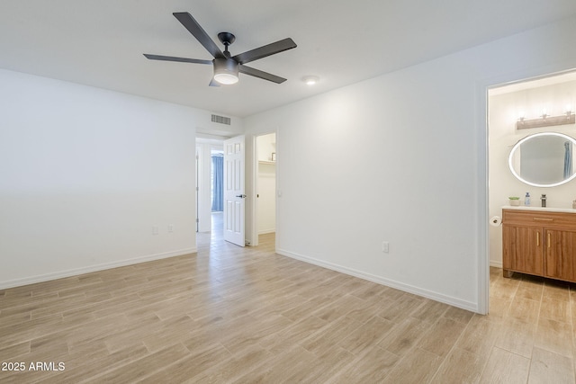 unfurnished bedroom with visible vents, baseboards, and light wood-style floors