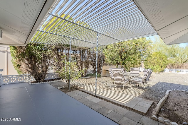 view of patio / terrace featuring a pergola and fence