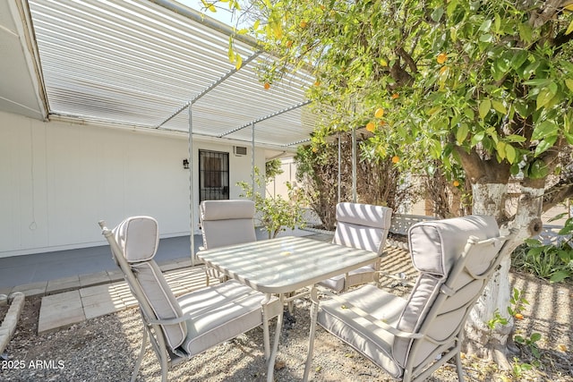 view of patio featuring a pergola and outdoor dining area