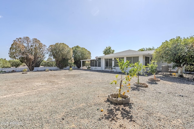 back of property with a sunroom