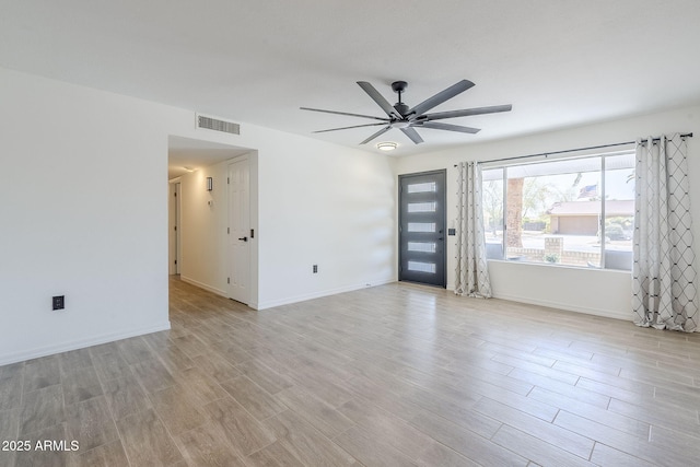 interior space with visible vents, baseboards, light wood-style floors, and ceiling fan