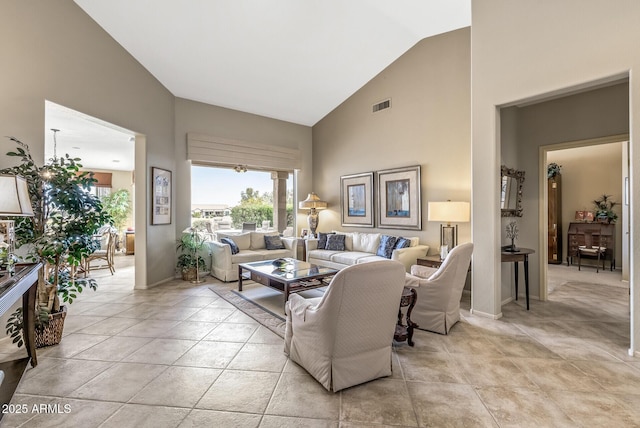 living room with high vaulted ceiling