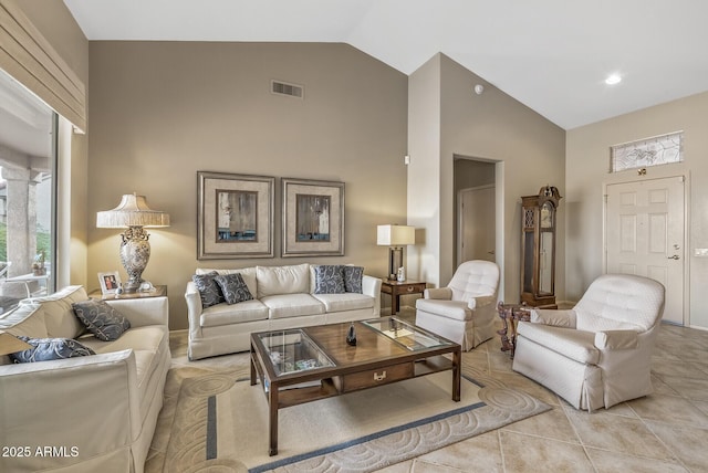 tiled living room featuring high vaulted ceiling