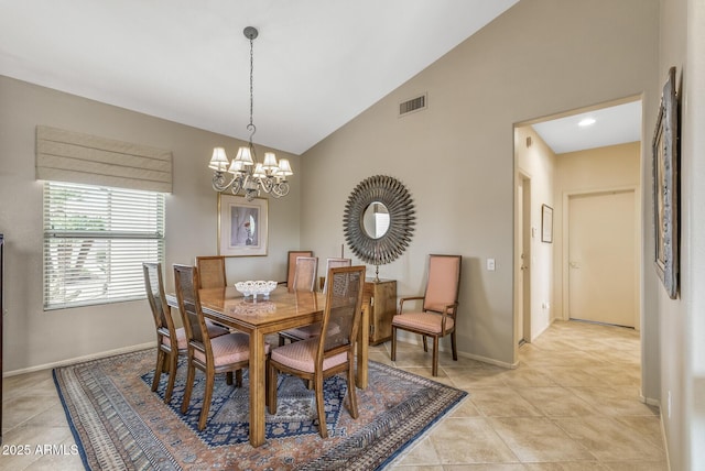 dining room featuring a notable chandelier, light tile patterned floors, and vaulted ceiling