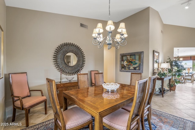 dining room featuring lofted ceiling, light tile patterned floors, and a chandelier